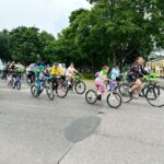 Rowerzyści jadący asfaltowa drogą