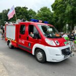 Rowerzyści jadący asfaltowa drogą