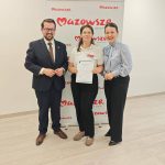 654199450_951497747225747_4599892382042685355_n Trzy osoby stoją przed banerem Mazowsze, jedna trzyma dyplom. Tło jasne, podłoga drewniana. Ubrani elegancko.